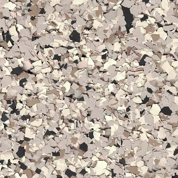 This image shows a textured surface with scattered, overlapping flakes in various shades of beige, gray, and black. No distinct landmarks visible.