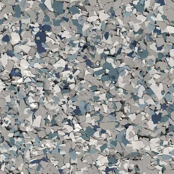 Abstract pattern composed of scattered, multi-colored paper or stone-like fragments in shades of gray, blue, and white, creating a textured background.