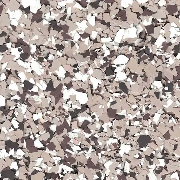 The image shows a close-up of beige, white, and black scattered flakes on a textured surface, resembling a floor or wall pattern.