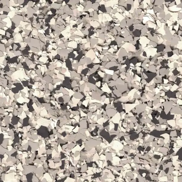 A textured surface with a scattered pattern of beige and gray shapes, resembling a close-up view of crushed material or stone.