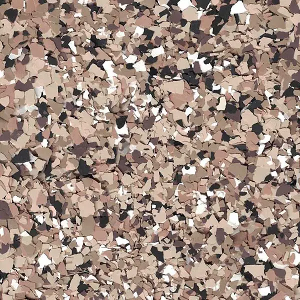 A close-up of a textured surface, featuring various shades of beige, brown, and black flakes randomly distributed across the image.